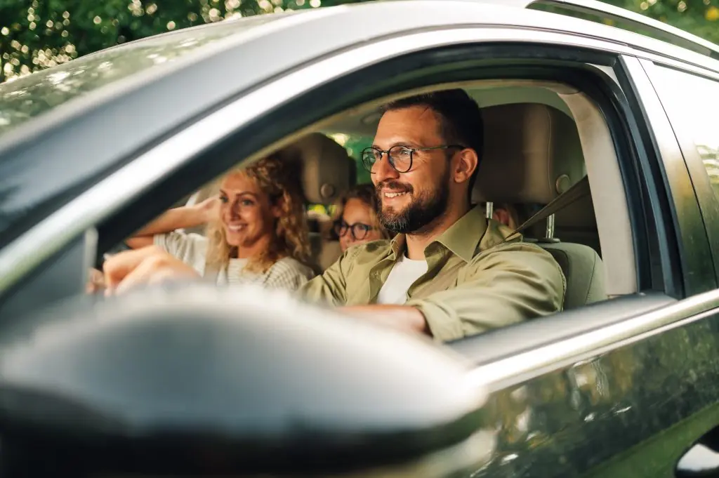 Family driving safely with a crystal-clear windshield installed