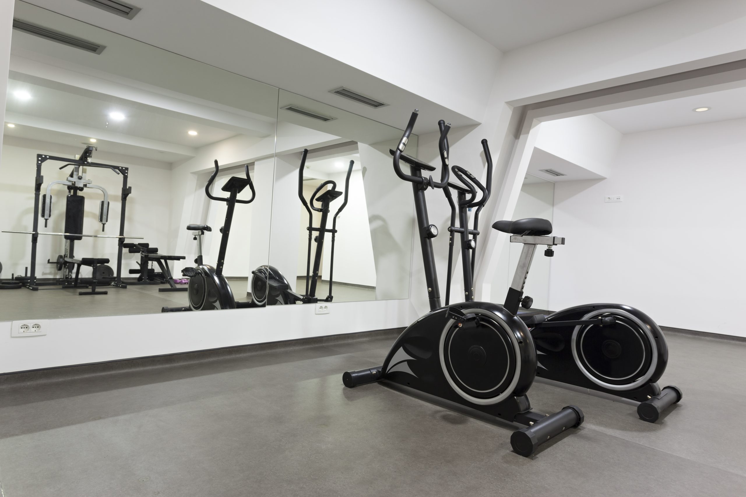 Spacious workout area featuring large wall mirror