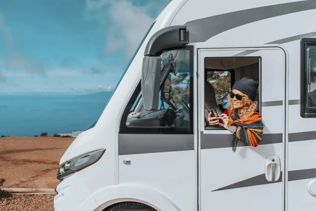 Camper van parked by ocean for RV window replacemen