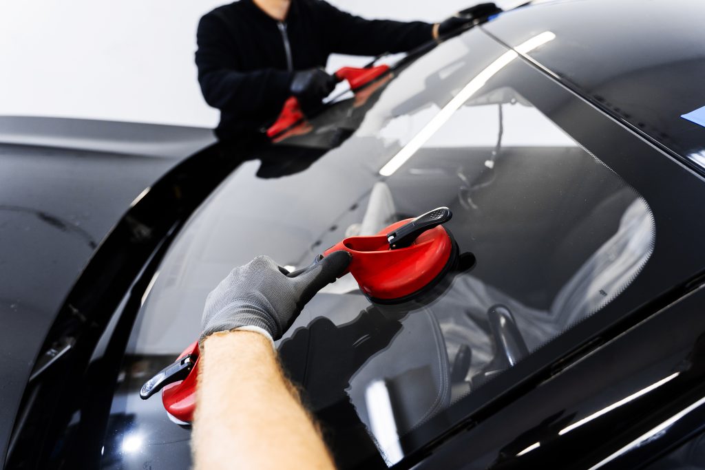 A certified Speedy Glass Technician inspecting damaged windshield.