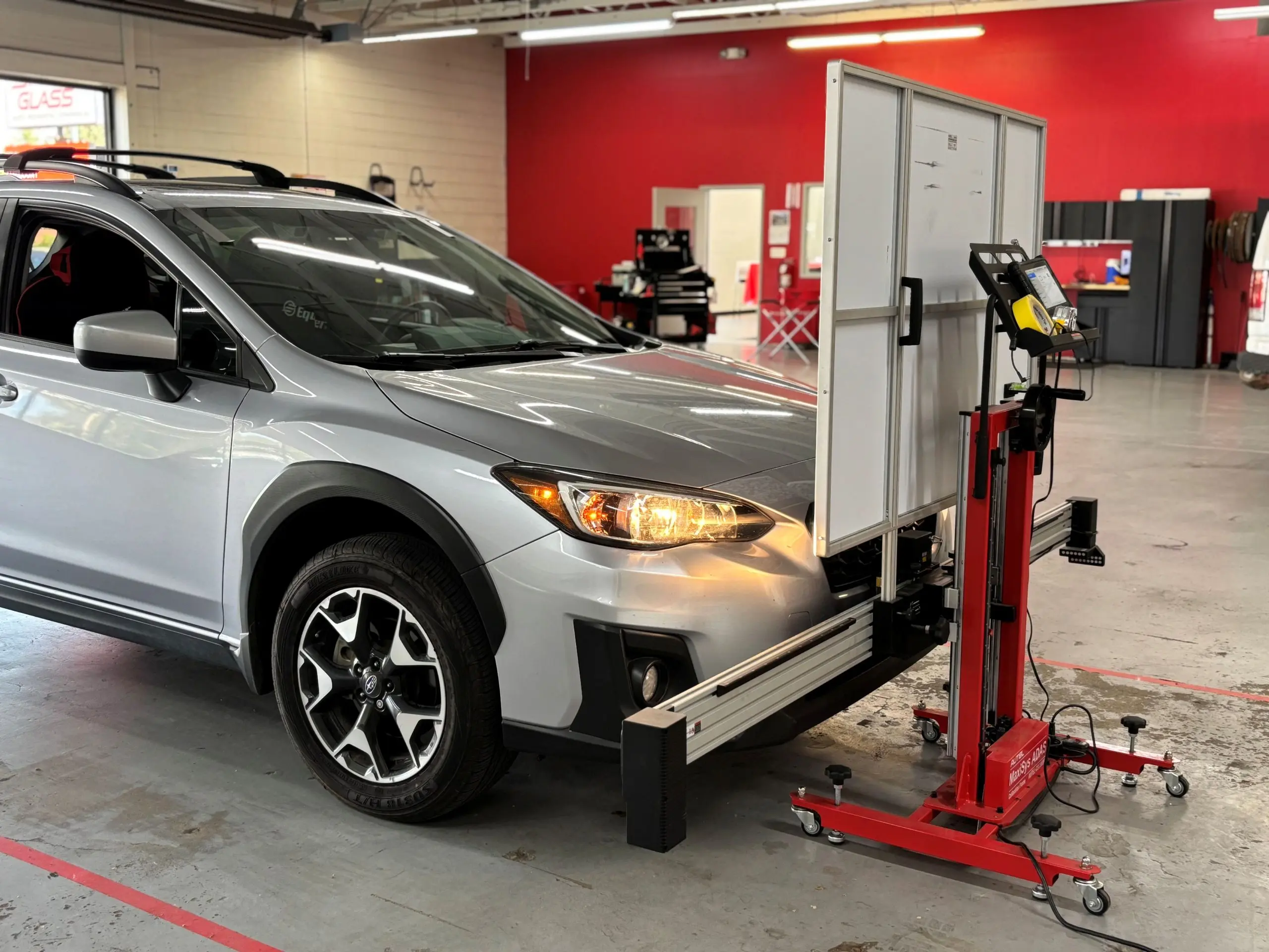 Professional ADAS windshield sensor calibration setup in a shop, highlighting the specialized equipment discount $99 windshield replacement services often skip.